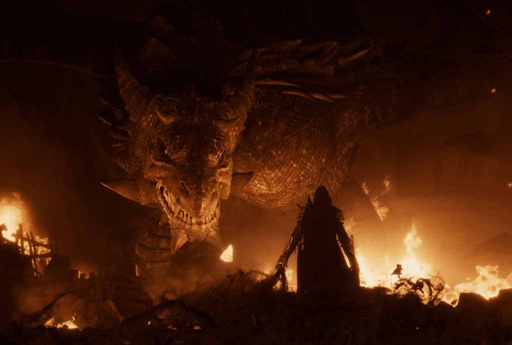 Dragon face à un personnage devant un incendie.